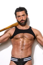 Muscular man in black athletic jockstrap, tank top, and striped socks holding baseball bat on turf